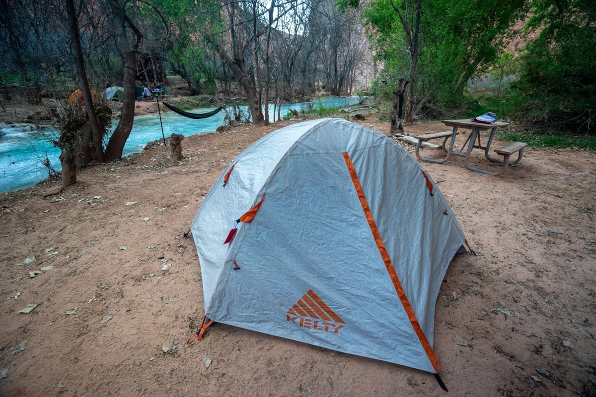 Tent at campsite next to turquoise Havasu Creek