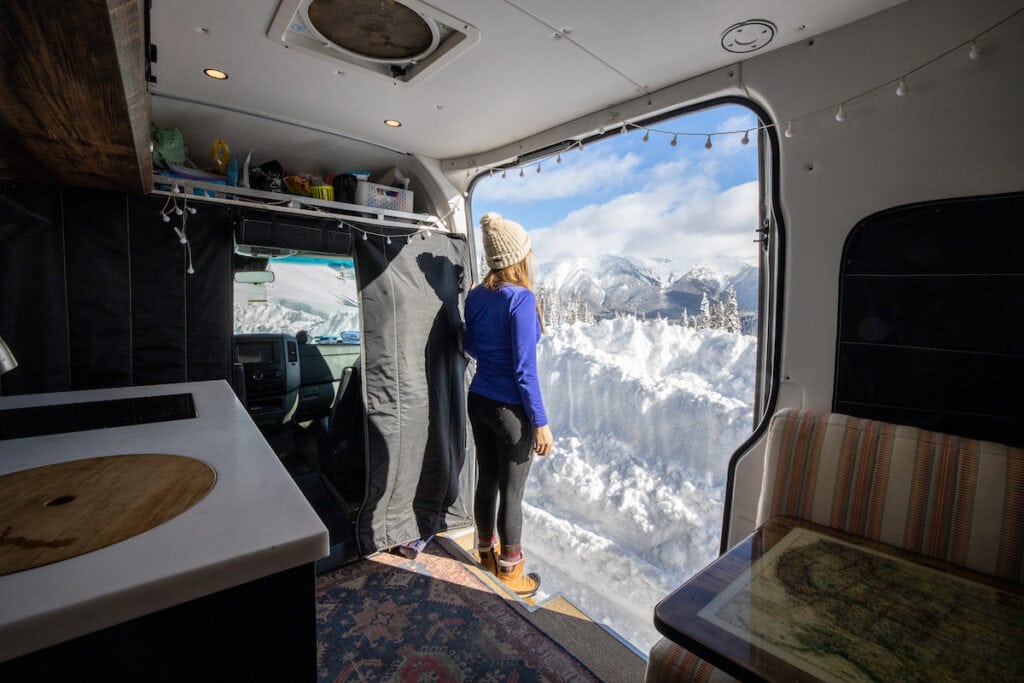 Kristen Bor wearing the Oasis Icebreaker 200 baselayer in her Sprinter Van at the top of Galena Summit in Idaho